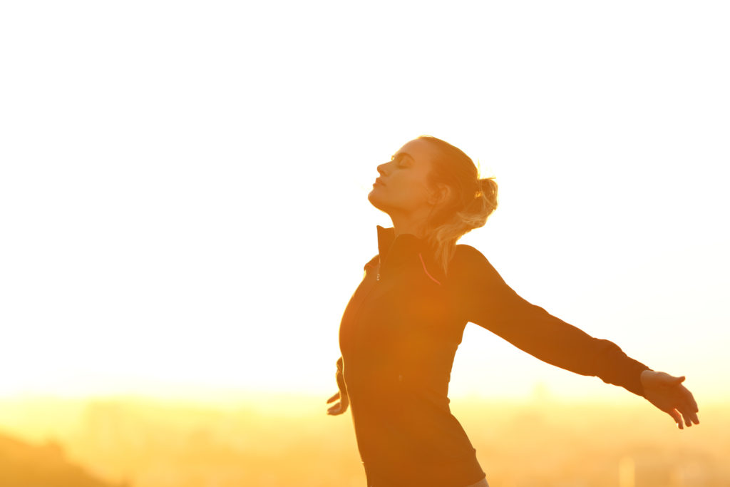 Runner resting breathing fresh air at sunset